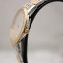 Side profile view of the Bulova watch, showing the gold-tone crown and thin case.