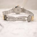 Close-up of the open fold-over clasp on the Bulova two-tone stainless steel bracelet.