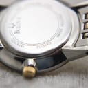 Close-up of the Bulova watch case back, showing model C935132, serial 15733820, and 'Water Resistant' engraving.