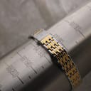 The Bulova two-tone bracelet on a wrist sizing gauge, indicating a circumference of approximately 188mm / 18.8cm.
