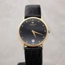 Front view of a gold-plated Raymond Weil 9124 quartz watch with a black dial and crystal hour markers on a black leather strap.