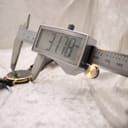 Digital caliper measuring the case diameter of the Raymond Weil watch, displaying a precise reading of 31.78mm.