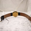 Rear view of the Raymond Weil watch showing the gold-plated case back and the full length of the black leather strap with a gold-tone buckle.
