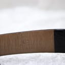 Close-up of the inner side of the black leather strap, showing the "CONDOR" brand embossed mark.