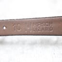 Underside of the watch strap showing "10 HIRSCH LIZARD" embossed text, indicating material and lug width.