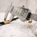 Digital caliper measuring the watch case, displaying a precise measurement of 17.18mm, confirming the exact case size.