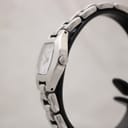 Side profile of the Tissot G333 watch on a stand, showing the curved tonneau-shaped case and original steel crown.