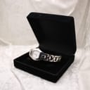 The Tissot G333 watch displayed inside an open black velvet presentation box.