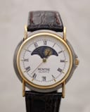Front view of Montine two-tone watch with white Roman numeral dial, moonphase display, and date window.