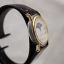Angled side view of the Montine watch on a display stand, highlighting the case and strap.