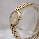 Angled view of the gold Raymond Weil watch, showing the bracelet links and crown.