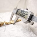 Digital caliper measuring the case diameter of the watch, displaying 20.02mm.