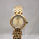 Front view of the Raymond Weil Fidelio watch with white dial, gold Roman numerals, and date window, on a gold-tone multi-link bracelet.