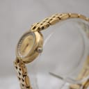 Angled side view of the Raymond Weil Fidelio watch showing the slim gold-tone case and bracelet on a display stand.