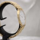 Another angled side view of the gold Raymond Weil watch highlighting the case profile and bracelet links.