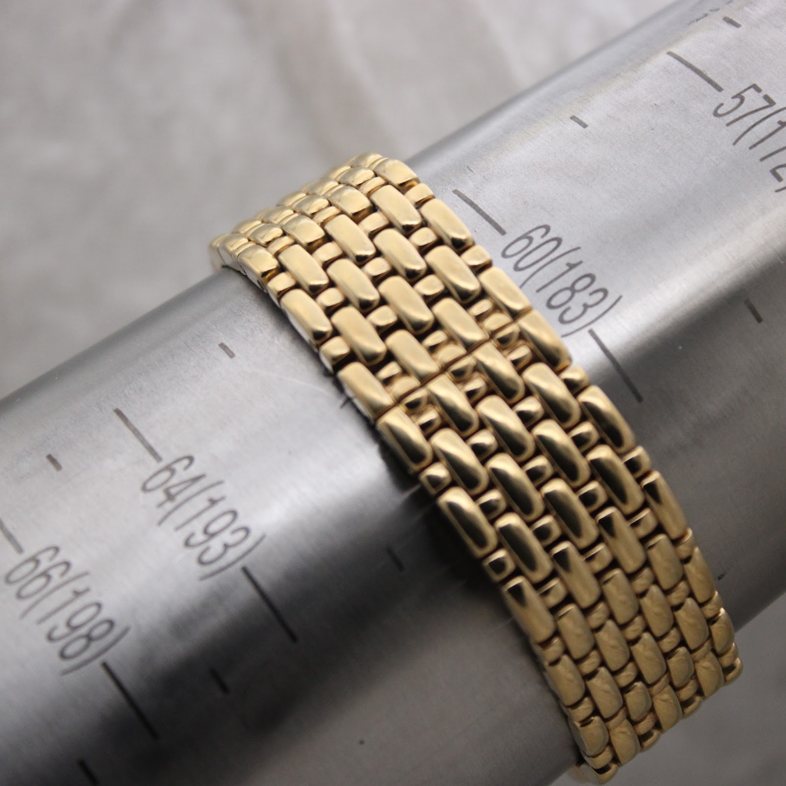 Rear view of the gold Raymond Weil watch bracelet showing the integrated design and an unbranded deployment clasp.