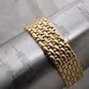 Rear view of the gold Raymond Weil watch bracelet showing the integrated design and an unbranded deployment clasp.