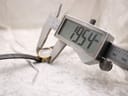 Digital caliper measuring the case diameter of the watch, displaying 19.54mm.