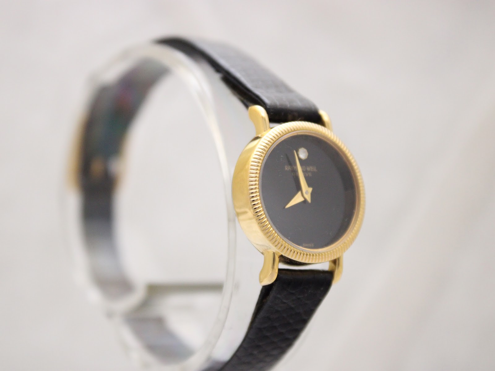 Another angled view of the Raymond Weil 544 watch, highlighting the minimalist dial and gold case.