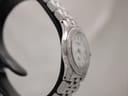 Side view of the Raymond Weil Tango watch, focusing on the sleek lines of the stainless steel case and integrated bracelet from the left side.