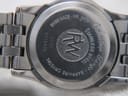 Close-up of the watch's stainless steel case back, engraved with "Swiss Made - WR. 5ATM", "Stainless Steel", "Sapphire Crystal", "Tango Collection", "RW" logo, and serial number "V316436 5790".