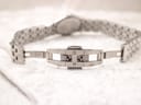 Close-up of the Raymond Weil stainless steel bracelet's double folding clasp, showing its "stainless steel" marking and internal mechanism.