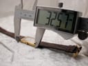 Digital caliper measuring the length of the watch case, displaying 32.57 mm