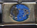 Close-up of the watch movement with the case back removed, showing the Swiss ETA 978.002 quartz movement and battery