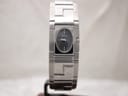 Front view of Versace ESQ99 watch with black rectangular dial and stainless steel greca bracelet on a stand.