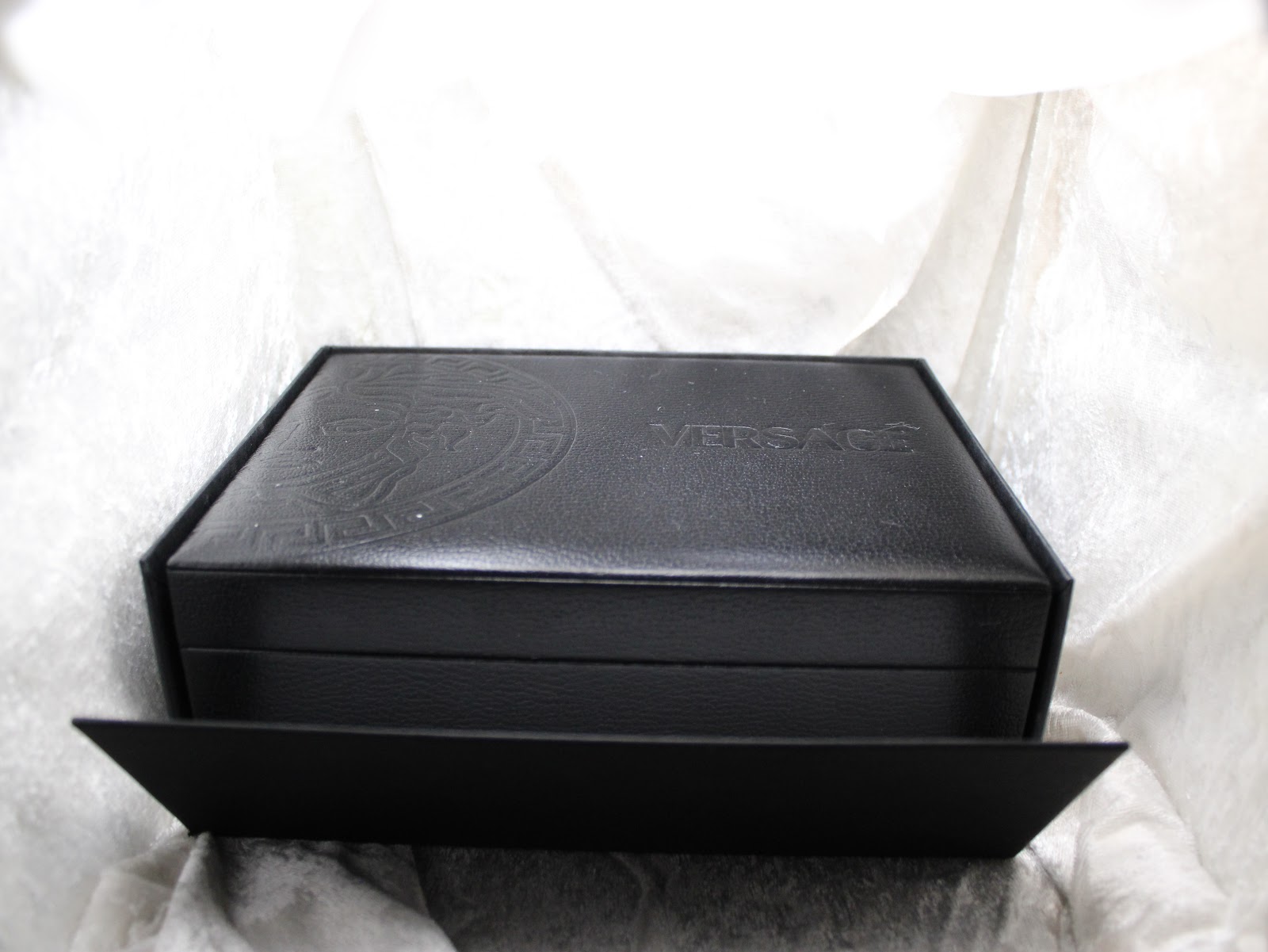 Side view of the closed Versace watch box, featuring the embossed Medusa head logo on the lid.