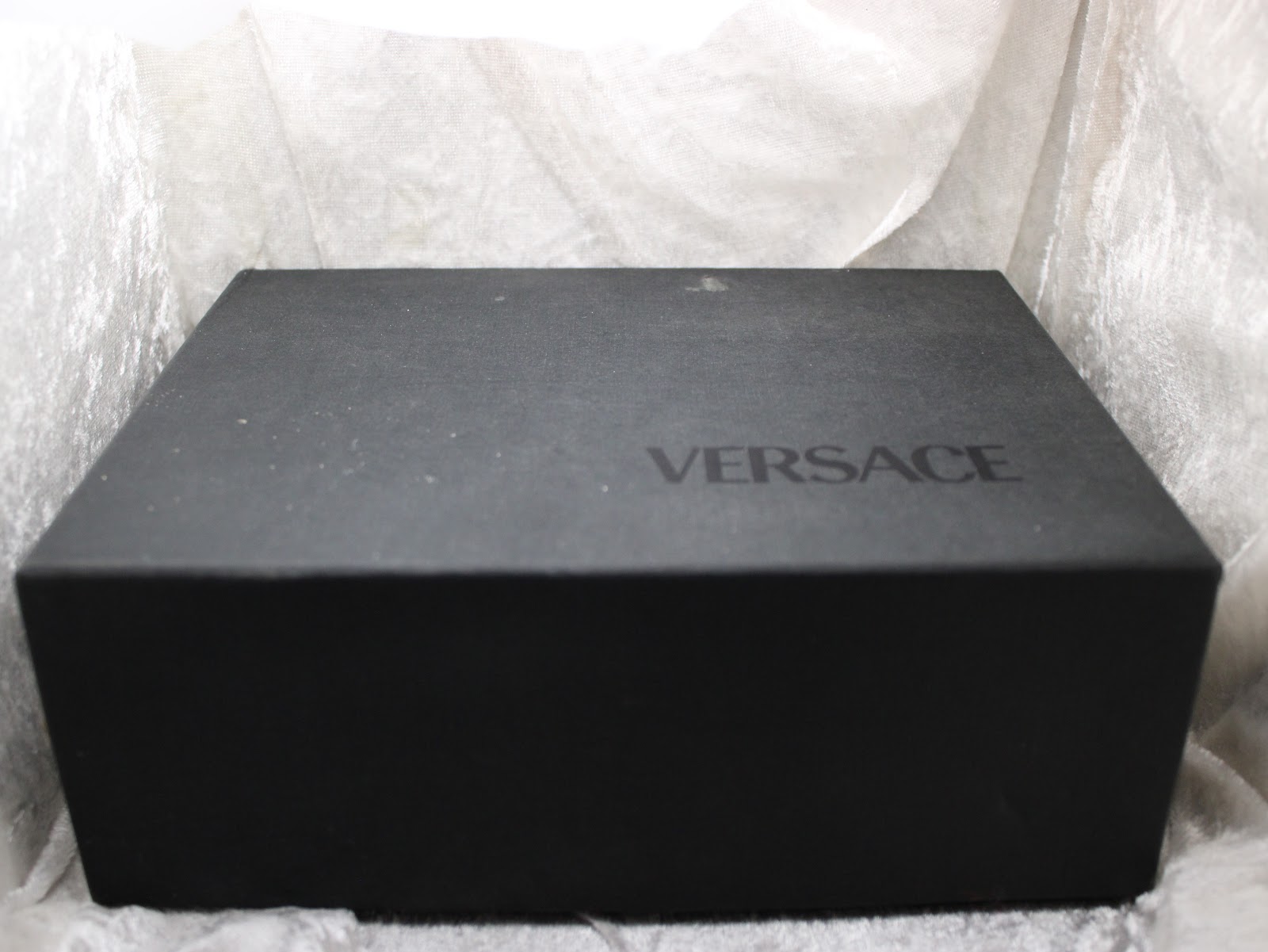 Top view of the closed outer Versace presentation box, with the brand name visible.