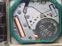 Close-up of the Seiko 6430 quartz movement inside the watch, displaying 7 jewels and a Renata battery.