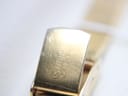 Close-up of the gold-tone clasp, clearly showing the 'R. WEIL GENEVE' signature engraving.