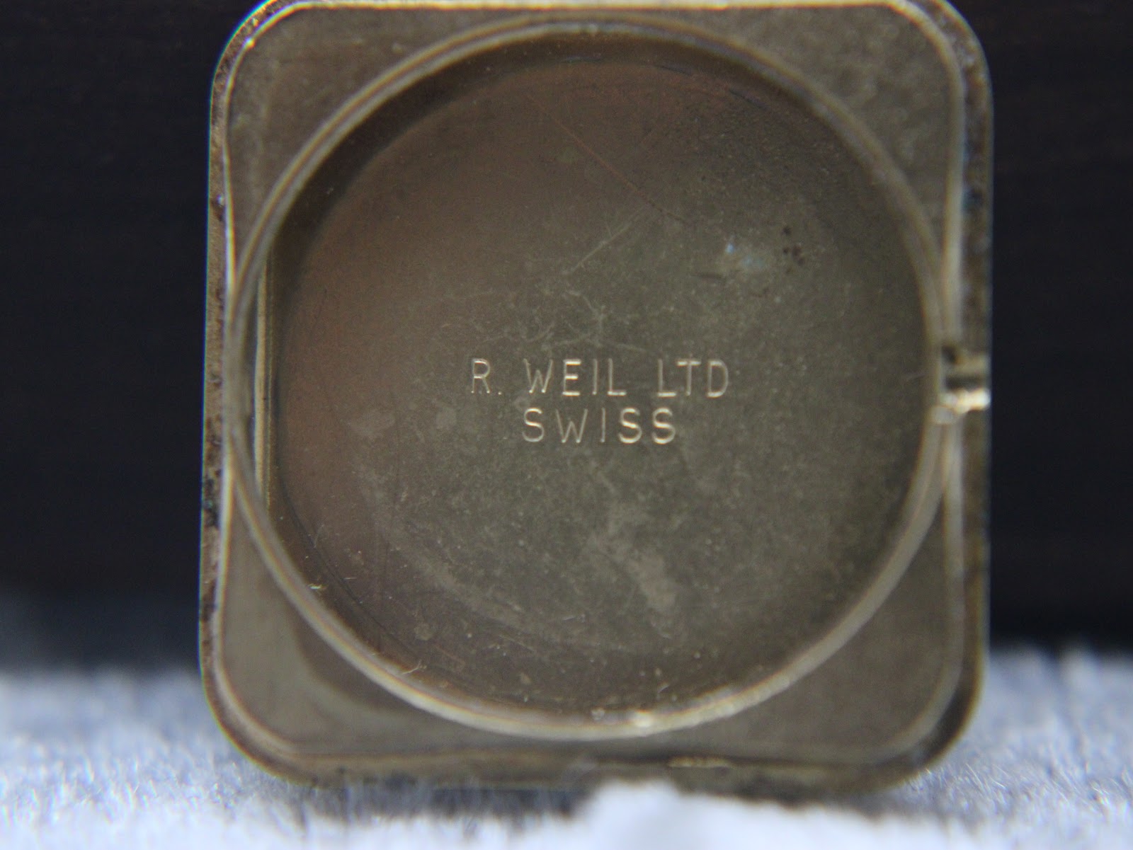 Inside view of the case back, engraved with 'R. WEIL LTD SWISS'.