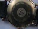 Close-up of the stainless steel case back of the Raymond Weil 9833, showing model number, serial, and water resistance.