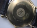 Another close-up of the Raymond Weil watch case back, focusing on the "RW" logo and engraved details.