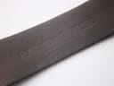 Close-up of the black leather strap's underside, revealing the "RAYMOND WEIL GENEVE" embossing.