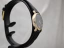 Another side view of the Raymond Weil 9923 watch on a stand, highlighting the case profile and black strap.