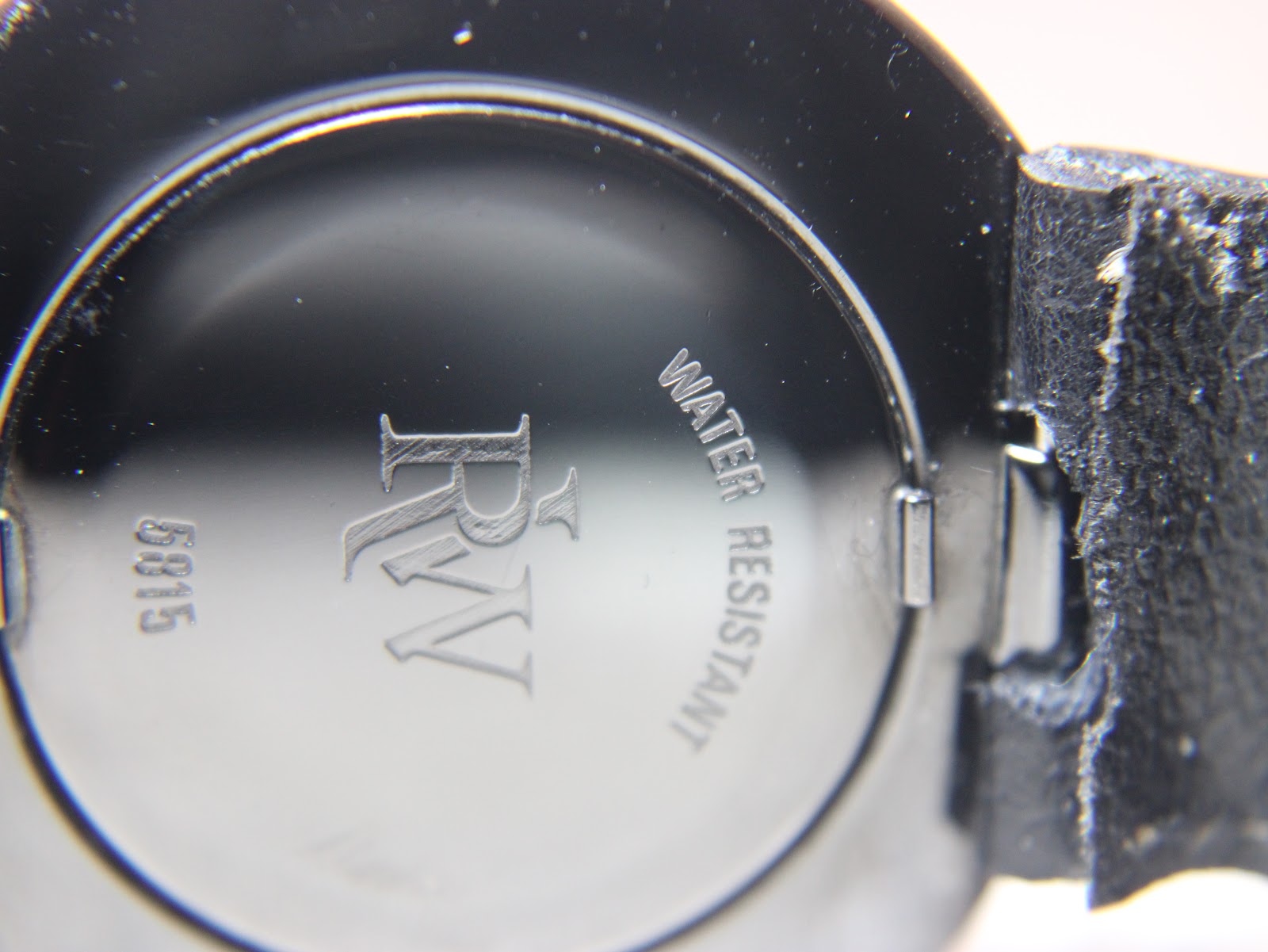 Close-up of the black case back, showing 'RW', '5815', and 'WATER RESISTANT' engravings.