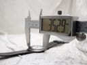 Digital caliper measuring the watch case, showing a precise diameter of 35.29mm.
