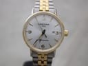 Front view of Certina DS Caimano watch with silver dial, gold indices, Arabic numerals, date window, and two-tone bracelet.