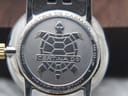 Close-up of the Certina DS Caimano titanium case back, featuring the Certina DS turtle logo and engraved details like water resistance and sapphire crystal.