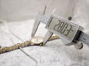 Digital caliper measuring the case diameter of the Certina DS Caimano watch, displaying a precise measurement of 28.03mm.