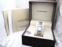 The Burberry BU4500 watch presented in its original brown box, with included booklets and spare bracelet links.