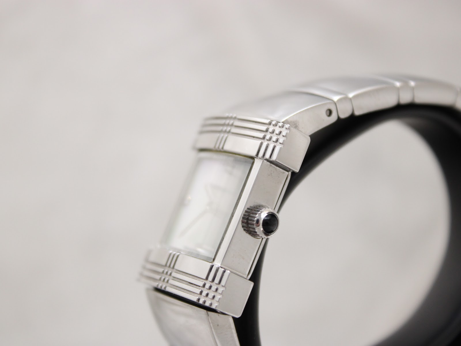 Side view of the Burberry BU4500 watch, focusing on the rectangular case profile and the black cabochon crown.