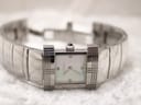 Full view of the Burberry watch laid open, displaying the integrated silver-tone bracelet and rectangular dial.