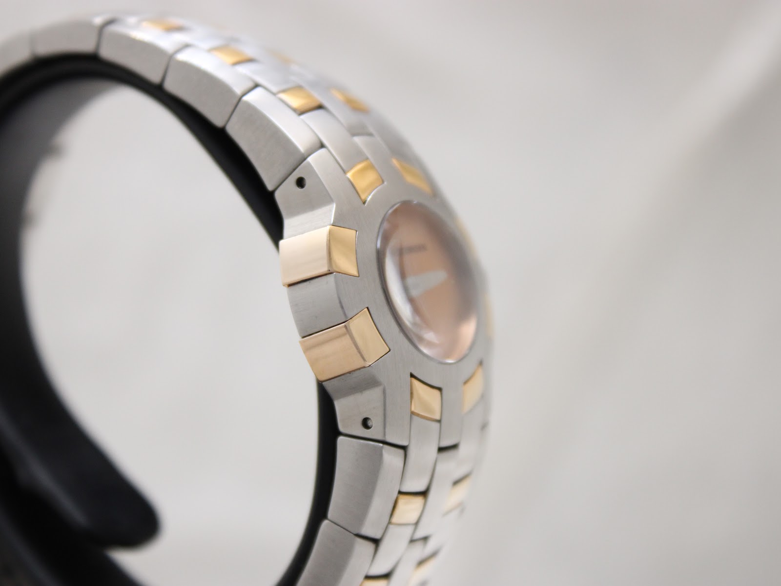 Another side view of the watch, highlighting the integrated two-tone stainless steel bracelet.