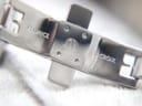 Close-up of the polished stainless steel deployant clasp, engraved with 'MAURICE LACROIX' logo.