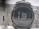 Detailed view of the case back, engraved with model number, serial, materials, and 50M water resistance.