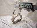 Digital caliper measuring the case diameter of the watch, showing a precise reading of 23.54mm.